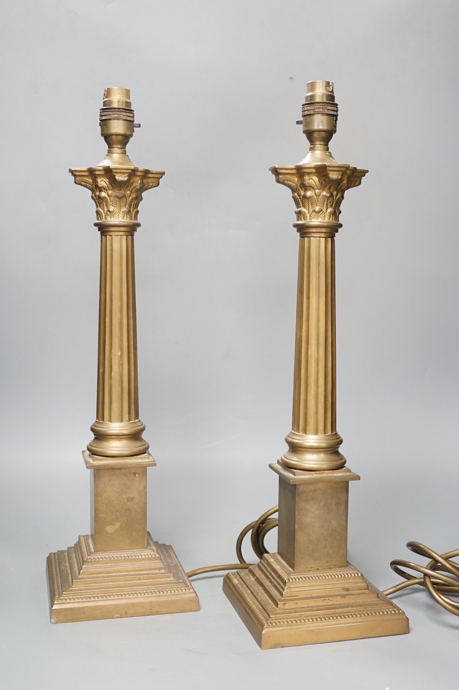 A pair of brass Corinthian column table lamps 48cm total